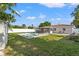 Backyard oasis with pool, screened lanai, and a grassy area offers the ultimate Florida lifestyle at 3555 Belle Vista E Dr, St Pete Beach, FL 33706