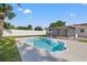 Inviting kidney-shaped pool with ample concrete decking, perfect for sunbathing and enjoying outdoor living at 3555 Belle Vista E Dr, St Pete Beach, FL 33706
