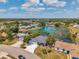 Aerial view of charming neighborhood homes around a lake with fountain at 3558 65Th Avenue E Cir, Sarasota, FL 34243