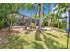 Landscaped backyard featuring a screened lanai and outdoor seating at 3558 65Th Avenue E Cir, Sarasota, FL 34243
