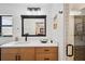 Updated bathroom with a glass shower, large mirror, and quartz countertop at 3558 65Th Avenue E Cir, Sarasota, FL 34243
