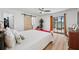 Spacious bedroom with a sliding glass door, ceiling fan, and laminate wood flooring at 3558 65Th Avenue E Cir, Sarasota, FL 34243
