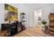 A stylish entryway with a unique ostrich art piece, a modern wine rack, and inviting plants at 3558 65Th Avenue E Cir, Sarasota, FL 34243