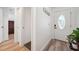 Bright hallway features lovely wood floors and a decorative front door with sidelight at 3558 65Th Avenue E Cir, Sarasota, FL 34243