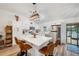 Bright kitchen featuring a stone countertop island with seating and modern appliances at 3558 65Th Avenue E Cir, Sarasota, FL 34243