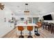 Bright kitchen with white cabinetry, stone island, stainless appliances, and counter seating at 3558 65Th Avenue E Cir, Sarasota, FL 34243