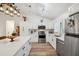 Bright kitchen with white cabinets, stainless steel appliances, and an island with a stone countertop at 3558 65Th Avenue E Cir, Sarasota, FL 34243