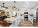 Spacious kitchen featuring white cabinets, stainless steel appliances, and a large island with seating at 3558 65Th Avenue E Cir, Sarasota, FL 34243