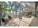 Relaxing screened lanai with outdoor seating offering picturesque lake views and a fountain at 3558 65Th Avenue E Cir, Sarasota, FL 34243