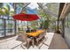 Screened lanai area offering a shaded outdoor dining space with waterfront views at 3558 65Th Avenue E Cir, Sarasota, FL 34243