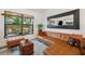Charming living room with leather couch, large window, modern decor, and plenty of space at 3558 65Th Avenue E Cir, Sarasota, FL 34243