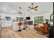 Open-concept living space featuring a modern kitchen, dining area, and comfortable lounge with ample natural light at 3558 65Th Avenue E Cir, Sarasota, FL 34243