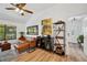 Bright living room with a vaulted ceiling, laminate floors, and wet bar that create an inviting atmosphere at 3558 65Th Avenue E Cir, Sarasota, FL 34243