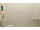 Modern bathroom featuring a pedestal sink, toilet, and decorative greenery at 36017 Joseph Blake St, Zephyrhills, FL 33541