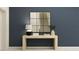 Stylish hallway featuring a decorative mirror above a modern console table, and lamp for ambient lighting at 36017 Joseph Blake St, Zephyrhills, FL 33541