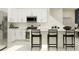 Bright, white kitchen with stainless steel appliances and sleek breakfast bar seating at 36017 Joseph Blake St, Zephyrhills, FL 33541