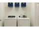 Clean laundry room with modern washer and dryer and ample storage space at 36017 Joseph Blake St, Zephyrhills, FL 33541