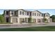 Charming townhome featuring a well-maintained lawn, a two-car garage, and a classic neutral-toned exterior at 36050 Risa Michele St, Zephyrhills, FL 33541