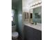 Clean and functional bathroom with a vanity, mirror, and toilet at 37643 Campo Ave, Zephyrhills, FL 33541