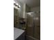Standard bathroom featuring a metal rack, neutral walls, and glass enclosed shower at 37643 Campo Ave, Zephyrhills, FL 33541