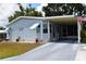 Charming single-story home featuring a carport, awnings, and well-maintained landscaping at 37643 Campo Ave, Zephyrhills, FL 33541