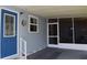 Home with a blue exterior door and screened in patio showing great curb appeal at 37643 Campo Ave, Zephyrhills, FL 33541