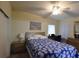 Serene bedroom with a ceiling fan, bed, and a well-lit desk area at 37643 Campo Ave, Zephyrhills, FL 33541