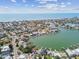 Picturesque aerial view showcasing a waterfront community with homes along canals leading to the open sea at 425 12Th Ave, Indian Rocks Beach, FL 33785
