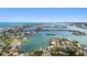 Overhead shot of waterfront homes, featuring private boat access and lush landscaping, on a bright, sunny day at 425 12Th Ave, Indian Rocks Beach, FL 33785