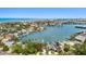 Stunning aerial perspective of a neighborhood featuring waterfront homes and lush greenery on a sunny day at 425 12Th Ave, Indian Rocks Beach, FL 33785