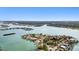 Expansive aerial shot of waterfront community showcasing homes with boat docks and the picturesque bay area at 425 12Th Ave, Indian Rocks Beach, FL 33785