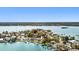 Breathtaking aerial shot of the waterfront property surrounded by clear blue water and neighboring residences at 425 12Th Ave, Indian Rocks Beach, FL 33785