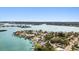 Stunning aerial view of waterfront homes with private boat docks, surrounded by lush greenery and sparkling blue water at 425 12Th Ave, Indian Rocks Beach, FL 33785