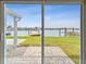 Home with sliding glass doors opening up to waterfront views and lush green backyard at 425 12Th Ave, Indian Rocks Beach, FL 33785