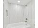 Close-up of a bright bathroom showcasing a shower over tub with marble-look tile and a built-in niche at 425 12Th Ave, Indian Rocks Beach, FL 33785