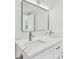 Bathroom featuring double vanity with marble countertop, modern lighting, and rectangular framed mirror at 425 12Th Ave, Indian Rocks Beach, FL 33785
