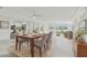 Bright dining area with modern furnishings, open floor plan, and water views from the windows at 425 12Th Ave, Indian Rocks Beach, FL 33785