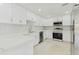 Modern kitchen with stainless steel appliances, white cabinetry, and stylish countertops at 425 12Th Ave, Indian Rocks Beach, FL 33785