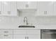 Close-up shot of a stainless steel sink and modern countertop details in a bright kitchen at 425 12Th Ave, Indian Rocks Beach, FL 33785