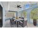 Outdoor lanai with seating for six under a ceiling fan, lattice accents, and views of the yard at 425 12Th Ave, Indian Rocks Beach, FL 33785