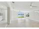 Bright and spacious living room featuring neutral color scheme, large windows with waterfront views, and tiled floors at 425 12Th Ave, Indian Rocks Beach, FL 33785