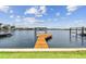 Waterfront home with long wooden pier and dock for mooring boats with serene blue waters at 425 12Th Ave, Indian Rocks Beach, FL 33785