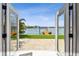 Beautiful waterfront view framed by open doorway and glass doors at 425 12Th Ave, Indian Rocks Beach, FL 33785