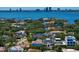Aerial view of a neighborhood with mature trees, waterways and city skyline in the background at 429 Erie Ave, Tampa, FL 33606