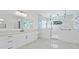 Elegant bathroom featuring a dual vanity, marble floors, and a glass-enclosed shower at 429 Erie Ave, Tampa, FL 33606