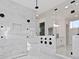 Modern shower with multiple showerheads, marble tile, and sleek glass enclosure, creating a luxurious experience at 429 Erie Ave, Tampa, FL 33606