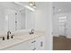 Bathroom with double sink, quartz countertop, black hardware, and walk-in closet at 429 Erie Ave, Tampa, FL 33606