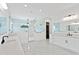 Bright bathroom featuring a large walk-in shower with glass door, double vanity, and sleek, modern fixtures at 429 Erie Ave, Tampa, FL 33606