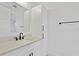 Contemporary bathroom features a white vanity with black hardware and a matching mirror at 429 Erie Ave, Tampa, FL 33606