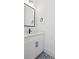 A bathroom featuring patterned floors, a white vanity, quartz countertop, and black fixtures at 429 Erie Ave, Tampa, FL 33606